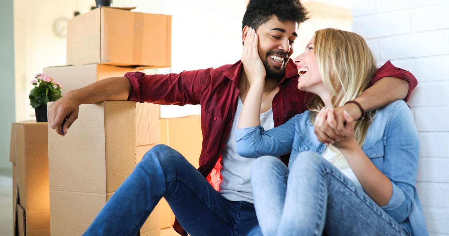 home, people, moving and real estate concept - happy couple having fun while moving in